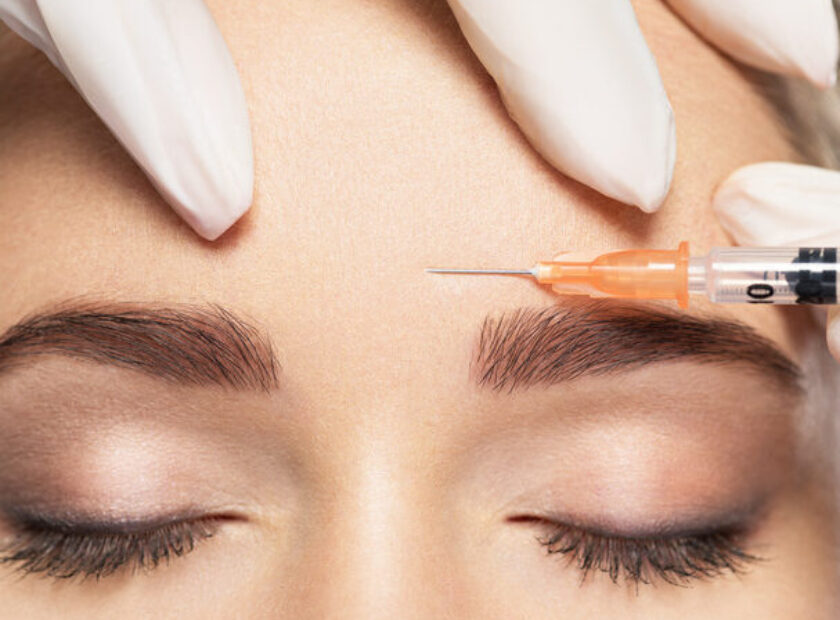 Woman getting cosmetic injection of botox near eyes